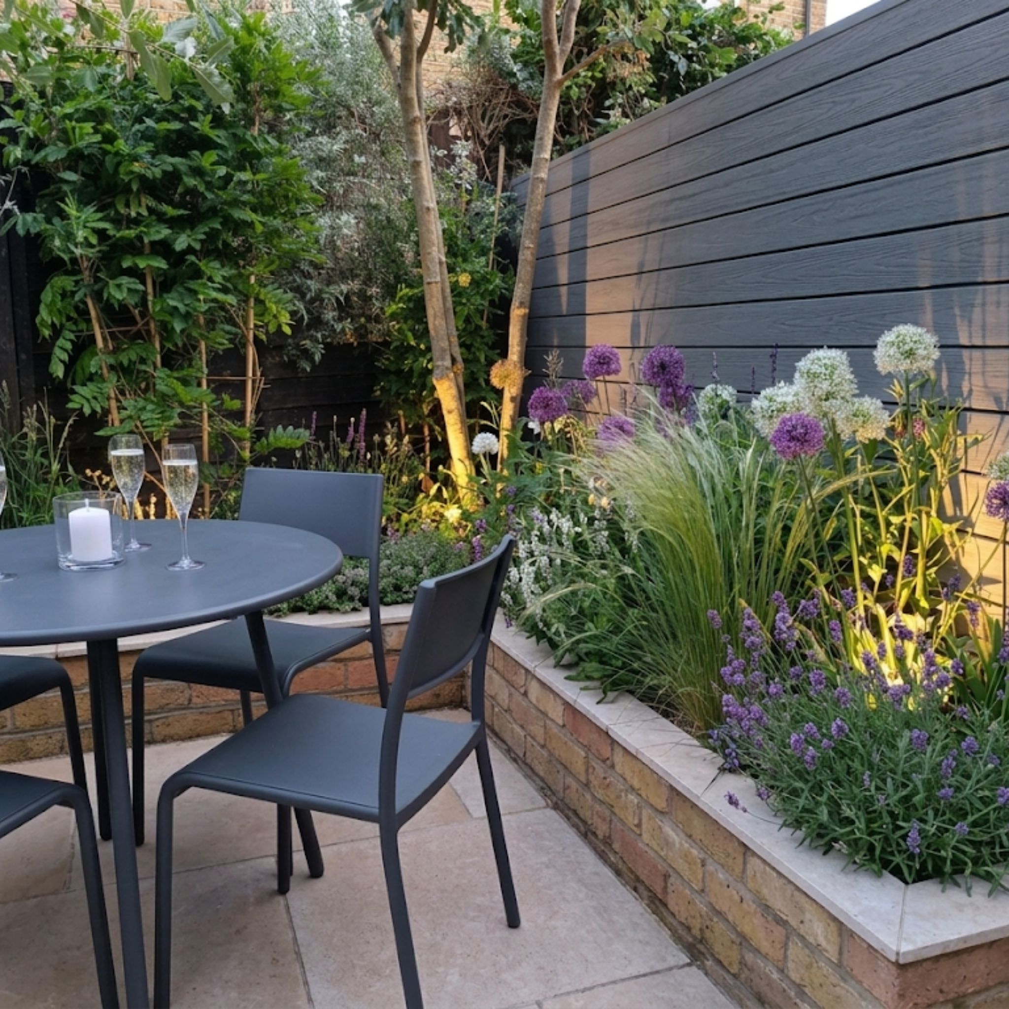 Daytime view of the low-maintenance courtyard with tumbled limestone pavers